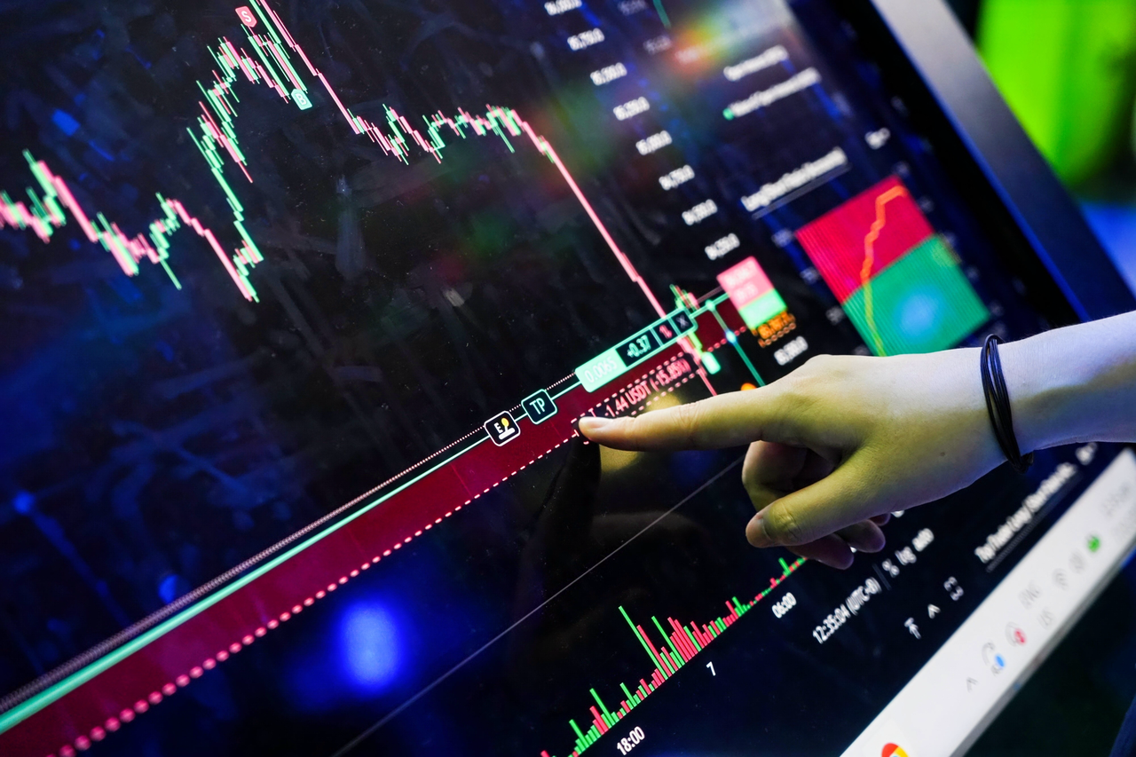 Visitors exploring the Bitunix interactive Trading Screen and live crypto charts at the TOKEN2049 Singapore booth.